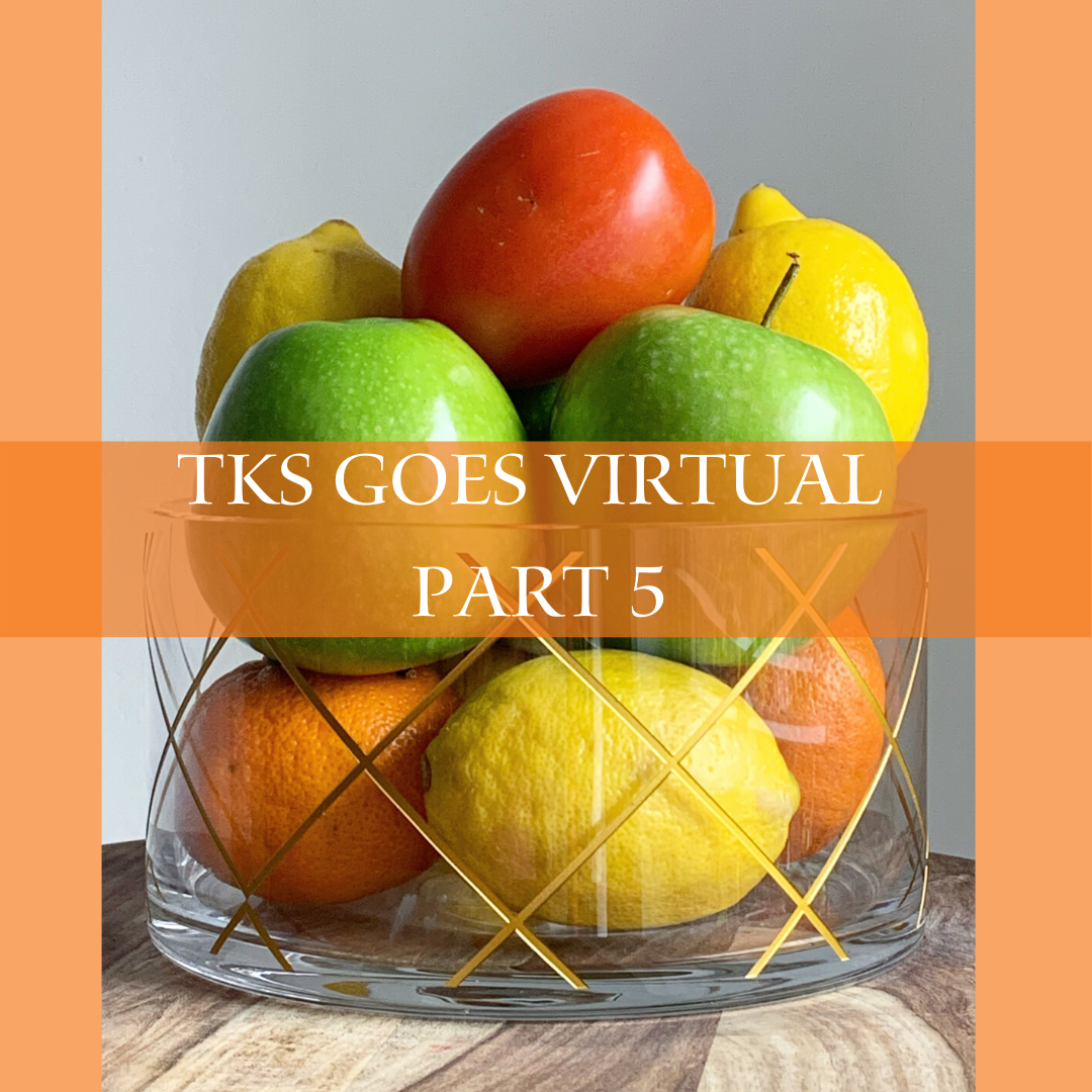 A clear glass bowl filled with assorted fruits, including apples, lemons, oranges, and a tomato, sits on a wooden surface. An orange banner across the center reads "TKS GOES VIRTUAL PART 5," symbolizing both the struggle and joy of adapting to virtual classes from a student perspective.