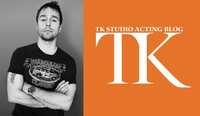 A person with short hair and a beard, reminiscent of Sam Rockwell's charismatic style, stands confidently in a t-shirt with arms crossed on the left. A bold orange rectangular block on the right displays the text "TK Studio Acting Blog TK" in white.