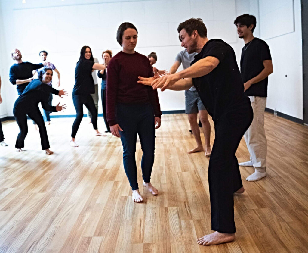 Acting students exploring physical responsiveness and specificity during a group training exercise at Terry Knickerbocker Studio.